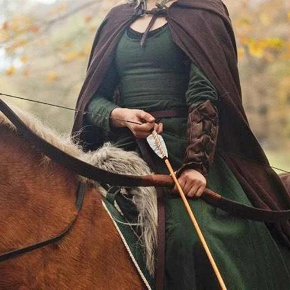 Medieval archeress sitting on horse, wielding a bow and arrow and wearing a brown laced bracer.