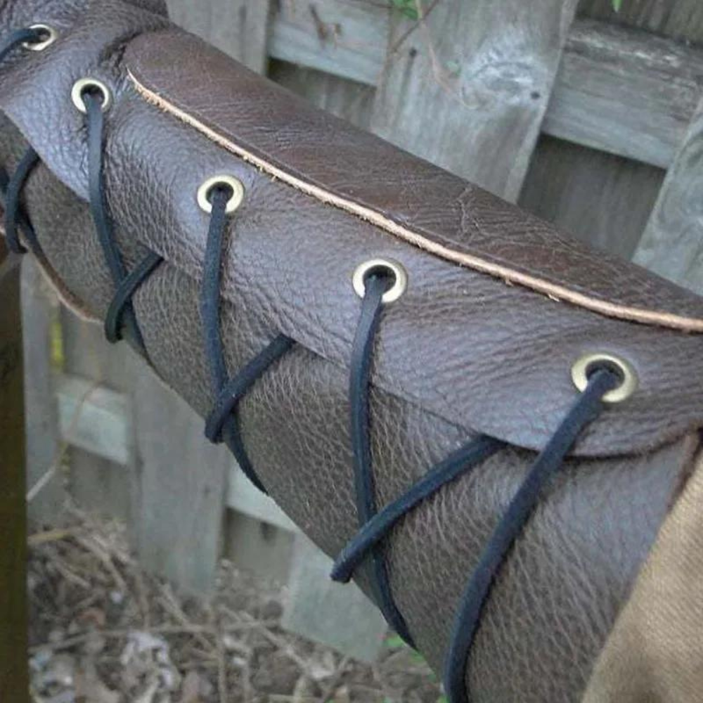 Brown laced bracer on archer's forearm, ideal for medieval cosplay.