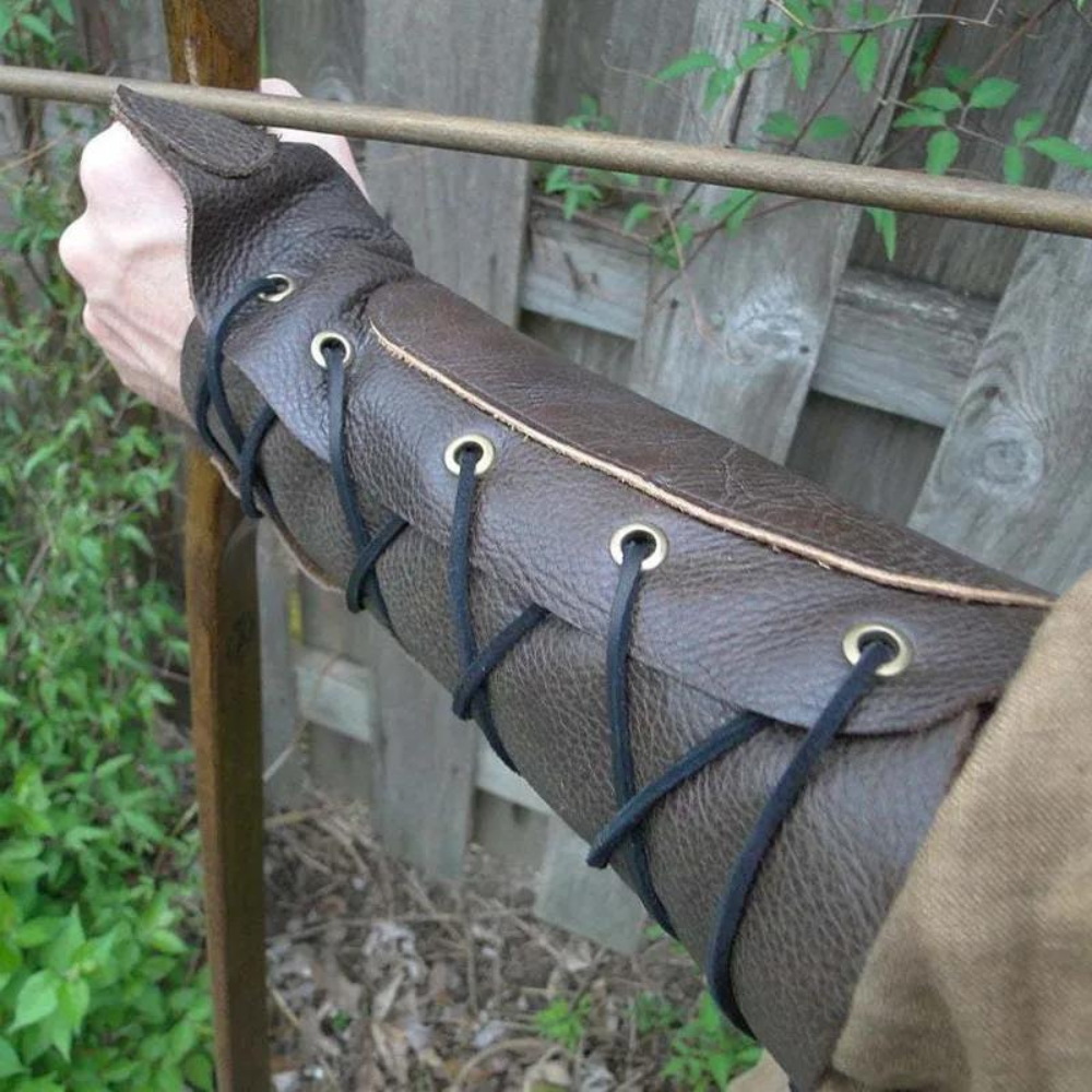 Brown laced bracer on archer's forearm, view of laces, ideal for medieval cosplay.