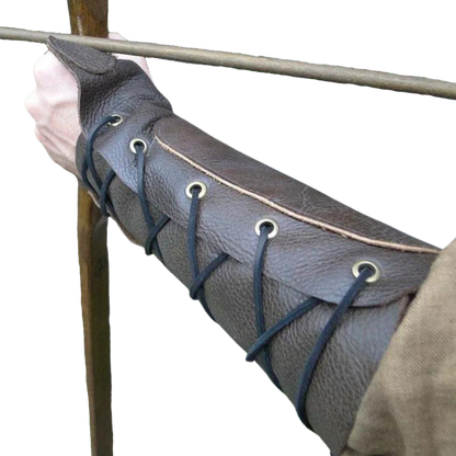 Brown laced bracer on archer's forearm, view of laces, ideal for medieval renaissance faire outfits.